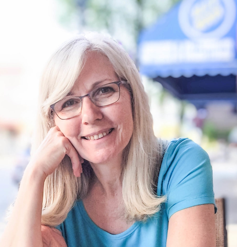 Author Francey True, Master Christian Life Coach, educated in trauma mental health, lifeskills, and mindset work. Helping you apply the Truth that transforms you. She is sitting outdoors on a sunny day wearing a turquoise t-shirt.